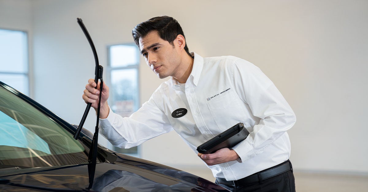 Technician inspecting wiper blades at a Buick service appointment